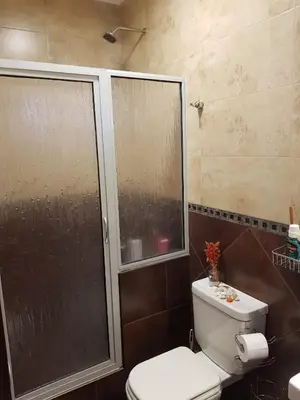 a bathroom with a toilet and a glass shower at MIracampo in San Antonio de Arredondo