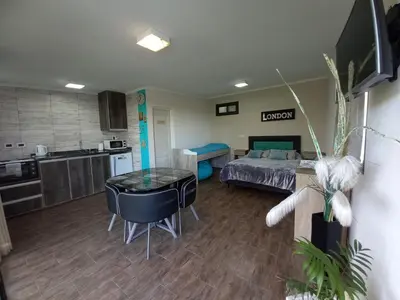 a living room with a bed and a kitchen at MIracampo in San Antonio de Arredondo