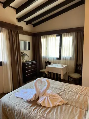 a bedroom with a swan towel on a bed at Juliette Posada Boutique Ex Posada La Villa in Villa Carlos Paz