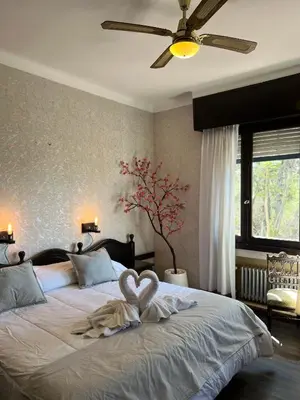 a bedroom with a bed with a heart decoration on it at Juliette Posada Boutique Ex Posada La Villa in Villa Carlos Paz