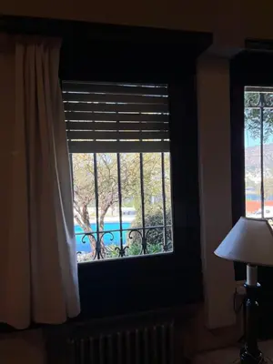 a window in a room with a view of a pool at Juliette Posada Boutique Ex Posada La Villa in Villa Carlos Paz