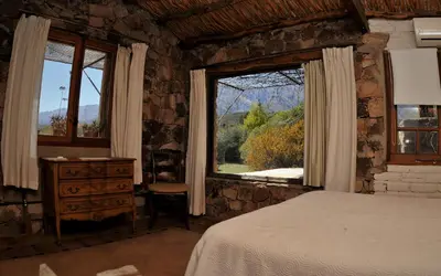 a bedroom with a bed and a window at LAS JARILLAS Hostería & Bodega in San Javier
