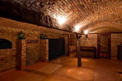 a room with a brick wall and a pole in it at LAS JARILLAS Hostería & Bodega in San Javier