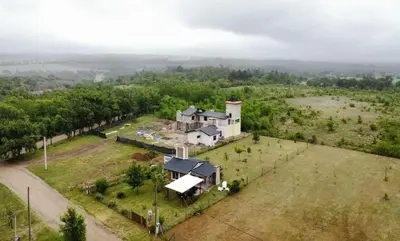 an aerial view of a house in a field at El Retiro - Casa de campo en Los Reartes in Los Reartes