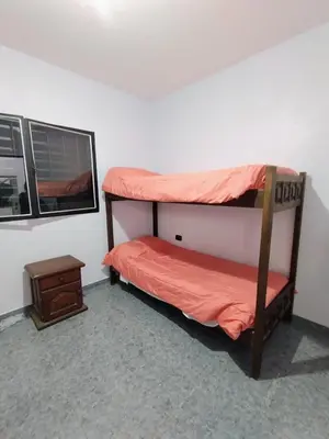 two bunk beds in a room with a window at Casa en Barrio Costa Azul in Villa Carlos Paz