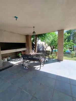 a patio with a table and a piano at Casa en Barrio Costa Azul in Villa Carlos Paz