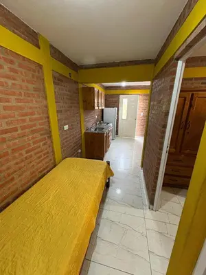 a room with a bed and a brick wall at La bendicion in Villa Cura Brochero