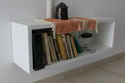 a white book shelf with a pile of books at Departamentos Córdoba Holder II in Cordoba