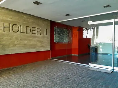 a lobby of a hotel with a sign on the wall at Departamentos Córdoba Holder II in Cordoba