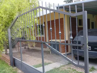 a metal gate in front of a house at La casita de Chany in Mina Clavero