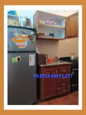 a kitchen with a stainless steel refrigerator and a counter at La casita de Chany in Mina Clavero