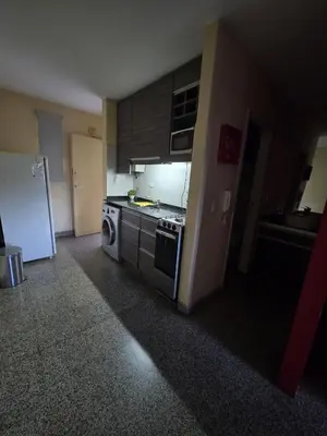 a small kitchen with a stove and a refrigerator at 76 Arruabarrena in Villa Carlos Paz
