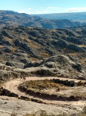 a group of people on a dirt road in the desert at Posada Las Vertientes in Copina