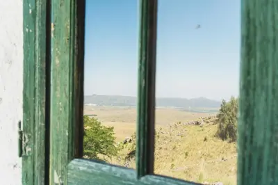 an open window with a view of a field at Posada Las Vertientes in Copina