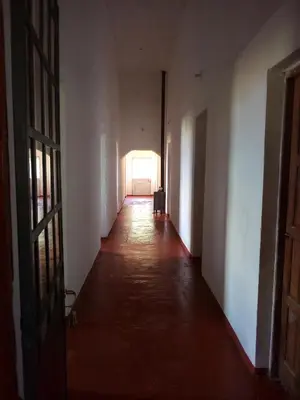 an empty hallway with a light at the end of a room at Posada Las Vertientes in Copina