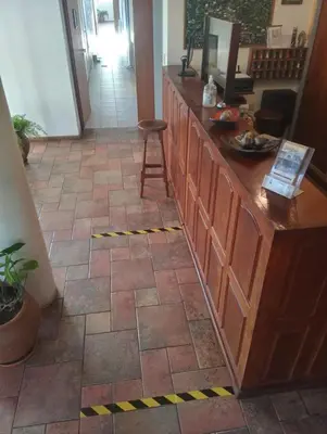 a lobby with a counter and a tile floor at Hotel Terrazas del Rincon in Merlo