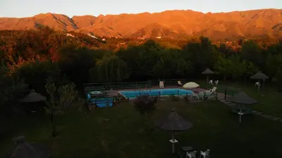 an aerial view of a swimming pool with mountains in the background at Hotel Terrazas del Rincon in Merlo