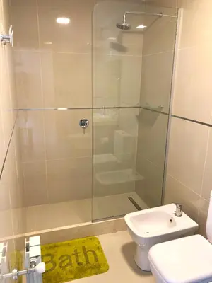 a bathroom with a shower and a toilet and a sink at Casonas de la Bahia in Villa Carlos Paz