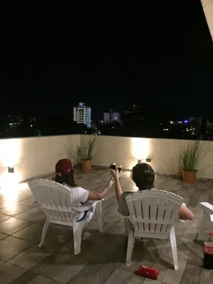 two people sitting in chairs on a patio at night at Torre del Lago I in Villa Carlos Paz