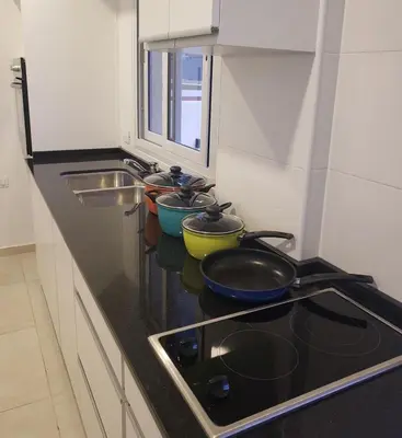 a kitchen counter with pots and pans on a stove at Torre del Lago I in Villa Carlos Paz