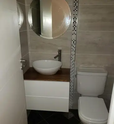 a bathroom with a sink and a toilet and a mirror at Torre del Lago I in Villa Carlos Paz