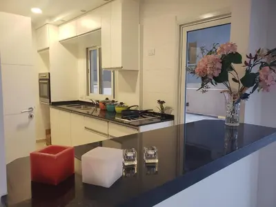 a kitchen with a counter with a vase of flowers at Torre del Lago I in Villa Carlos Paz