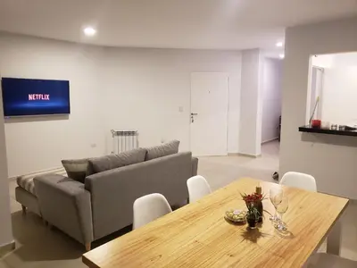 a living room with a couch and a wooden table at Torre del Lago I in Villa Carlos Paz