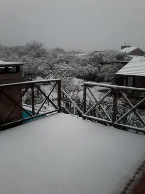 a bridge covered in snow next to a forest at Bosysol en las sierras in Merlo