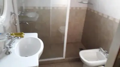 a bathroom with a shower and a toilet and a sink at Bosysol en las sierras in Merlo
