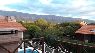 a view of the mountains from the balcony of a house at Bosysol en las sierras in Merlo