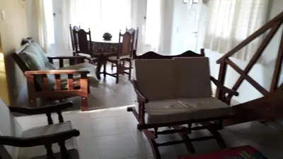 a living room filled with chairs and a table at Bosysol en las sierras in Merlo