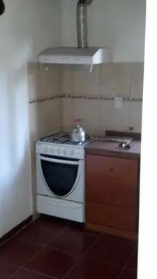 a kitchen with a stove with a tea kettle on it at Cabañas las Vertientes in Villa Parque Siquiman