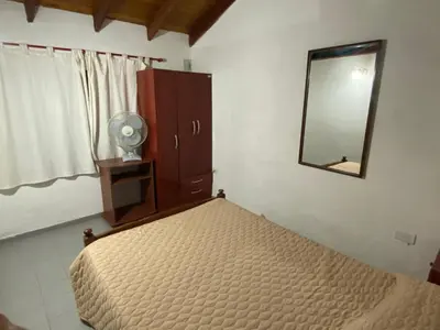 a bedroom with a bed and a mirror at Dos ruedas in Mina Clavero