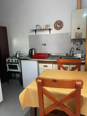 a kitchen with a table and a stove at Dos ruedas in Mina Clavero