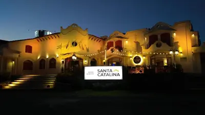 a large building with a sign in front of it at Hotel Santa Catalina in Río Cuarto