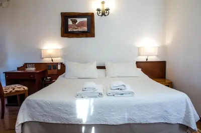 a bedroom with a bed with towels on it at Hotel Santa Catalina in Río Cuarto