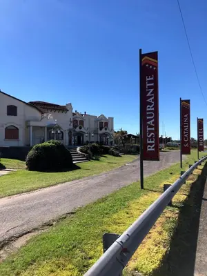a street with signs in front of a house at Hotel Santa Catalina in Río Cuarto