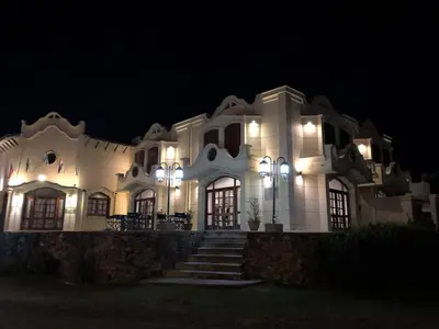 a large white building with lights at night at Hotel Santa Catalina in Río Cuarto