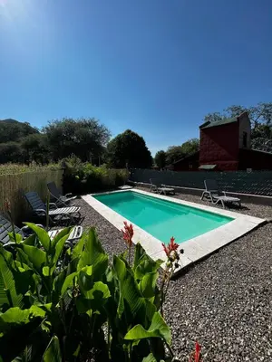 a swimming pool in the middle of a yard at Cabañas Luz de Luna in Santa Rosa de Calamuchita