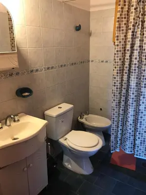 a bathroom with a toilet and a sink at Cabañas Luz de Luna in Santa Rosa de Calamuchita