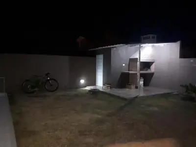 a bike parked in front of a house at night at Complejo LUMA, Con Pileta in Villa Dolores