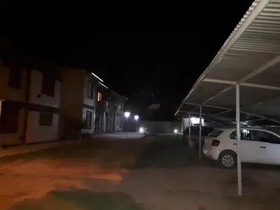 a white car parked in a parking lot at night at Complejo LUMA, Con Pileta in Villa Dolores