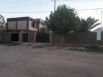 a building with a tree in front of it at Complejo LUMA, Con Pileta in Villa Dolores
