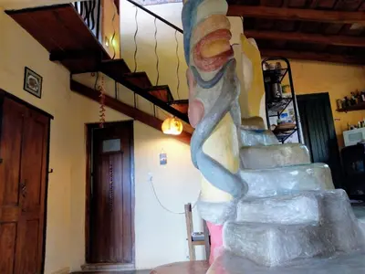 a statue of a person walking down a staircase at Casa Amarilla in Mina Clavero