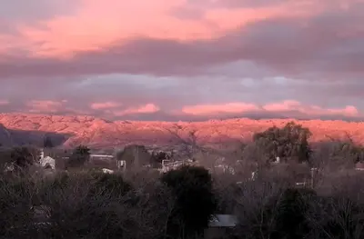 a view of a mountain under a pink sky at Casa Amarilla in Mina Clavero
