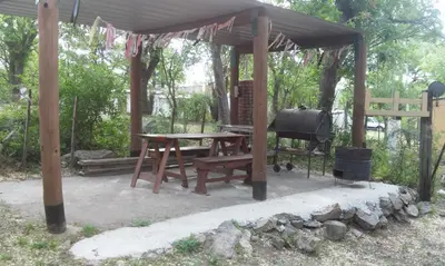 a picnic shelter with a picnic table and a grill at Cabañas Pancho Segunda Usina in Embalse