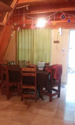 a dining room with a table and chairs and a room with a table at Cabañas Pancho Segunda Usina in Embalse