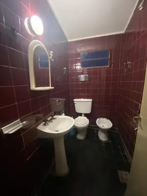 a bathroom with a sink and a toilet and a mirror at Cerro Chico Brochero in Villa Cura Brochero