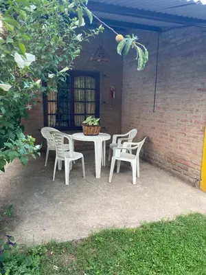 a white table and chairs with a potted plant on it at Cerro Chico Brochero in Villa Cura Brochero