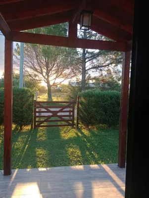 a wooden gate with a fence in a yard at Posada Entre Dos in Mina Clavero